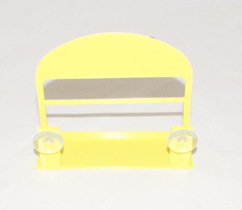 The Solar Strive card stand: a safety-yellow moulded holder with suction cups, standing empty on a white surface.